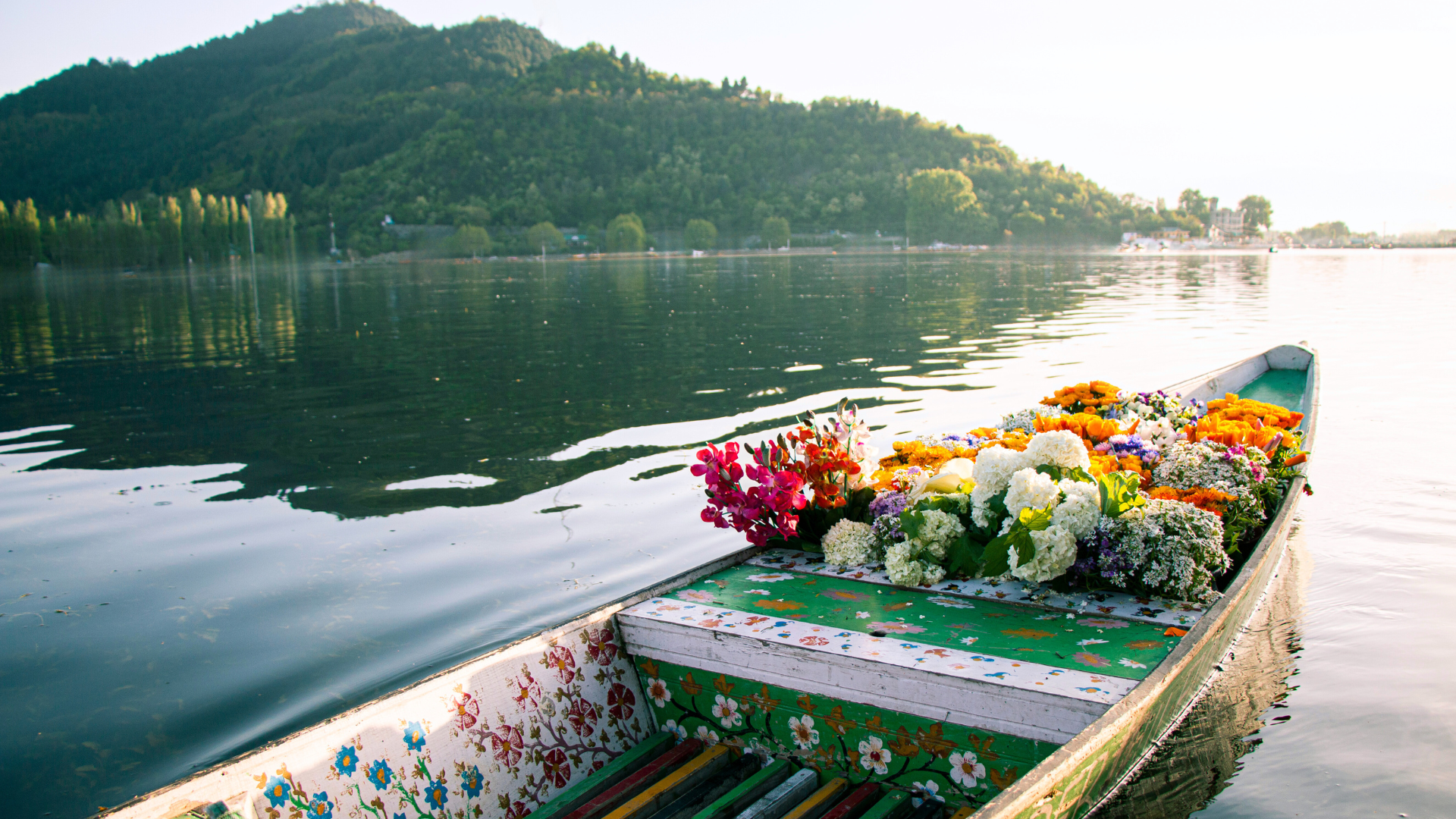 Painted canoe on the water full of flowers